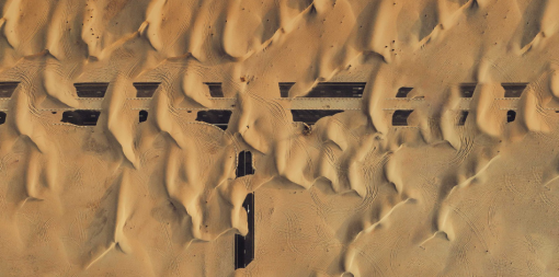 abandoned-road-junction-covered-by-sand-seen-from-directly-above
