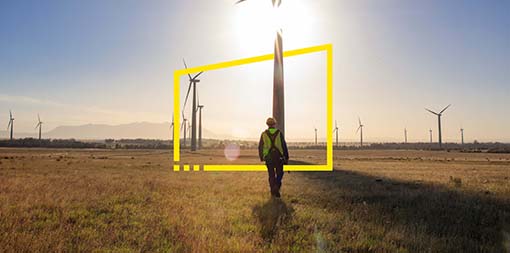 ey-engineer-walking-on-a-wind-farm-at-sunset