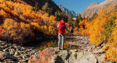 ey-female-hiker-with-backpack-enjoying-view-in-the-autumnal-mountains