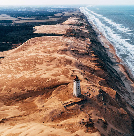 High-angle-view-of-lighthouse-on-hill-by-sea-denmark