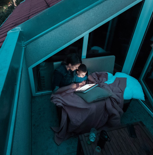 Mother-and-son-reading-bedtime-stories-at-the-balcony-on-the-e-reader