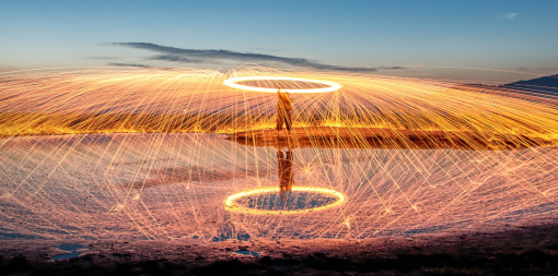 ey-person-making-light-painting-with-reflection-in-water