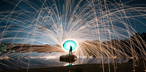 ey-silhouette-of-a-person-spinning-wire-wool-against-a-night-sky