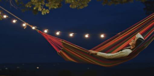 /ey-woman-hammock-night-garden-still