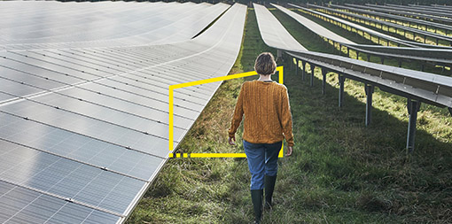 ey-young-female-farmer-walking-through-solar-farm