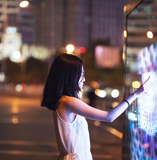 ey-young-woman-using-touch-screen-on-the-street.jpg